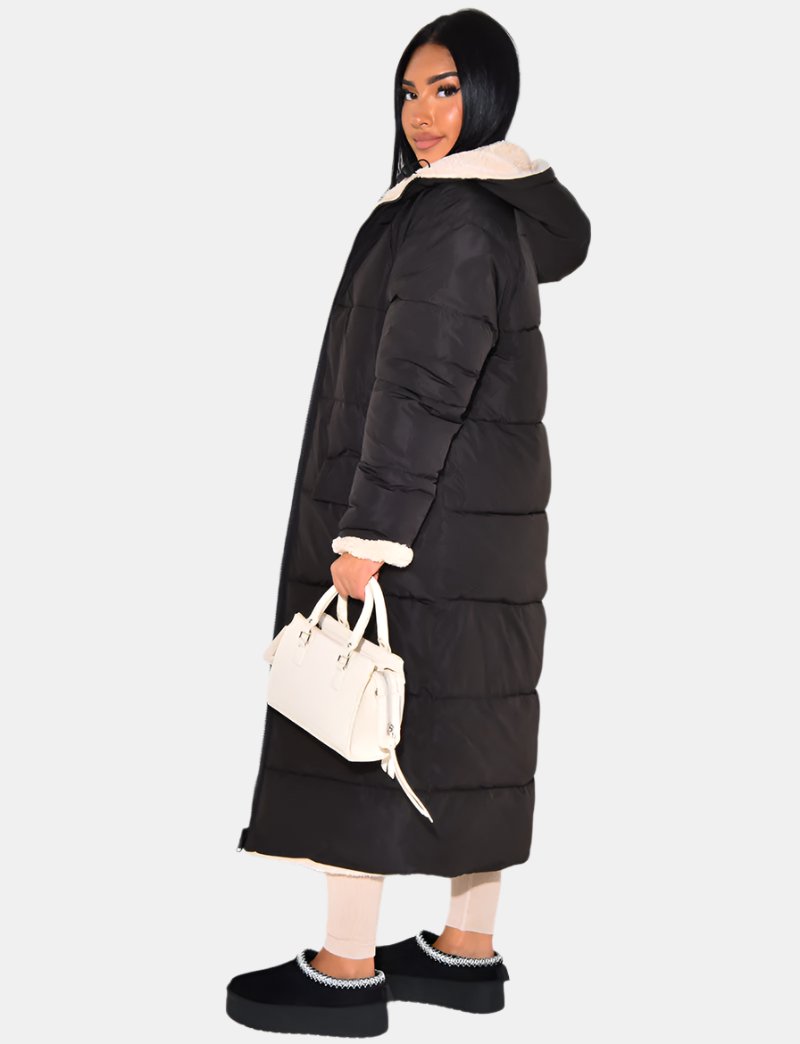 Stylish women's long hooded puffer coat in a modern color, ideal for warm winter fashion and casual outerwear.