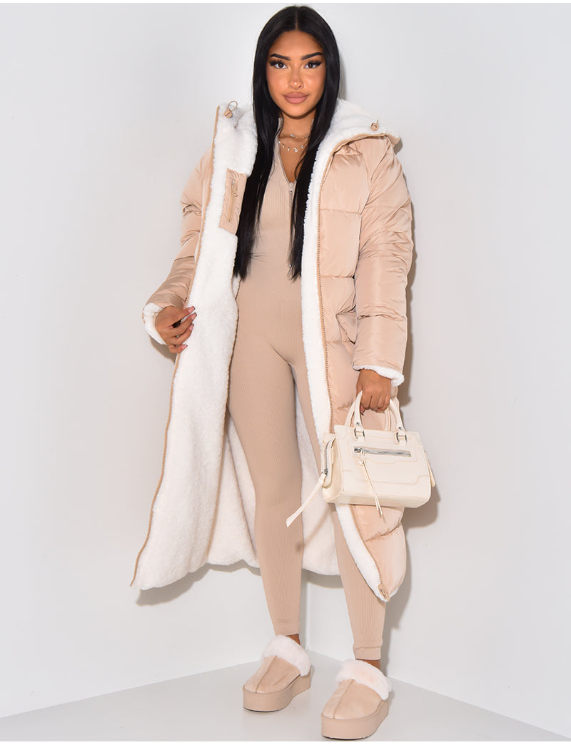 Cozy women's long puffer jacket with a functional hood. Warm quilted winter coat for cold weather casual wear.