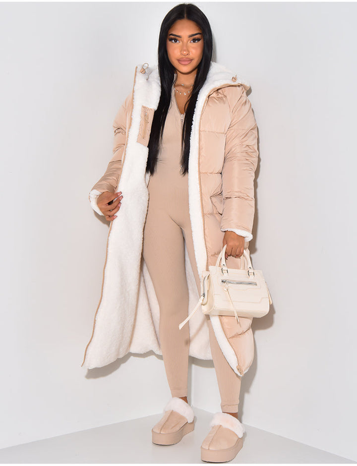 Cozy women's long puffer jacket with a functional hood. Warm quilted winter coat for cold weather casual wear.