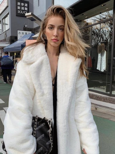 Women's long faux fur jacket in a chic, elegant style for cozy winter fashion.