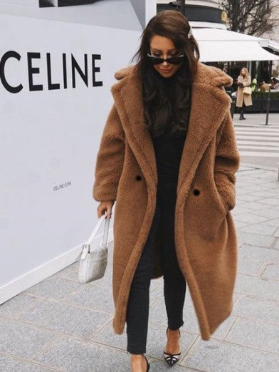 Trendy women's outerwear: a fashionable long faux fur jacket perfect for winter.