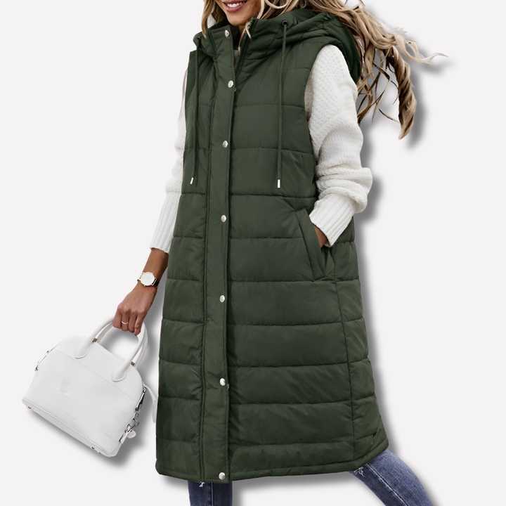 Padded women's long hooded vest, a cozy bodywarmer and sleek sleeveless jacket for cold weather layering.