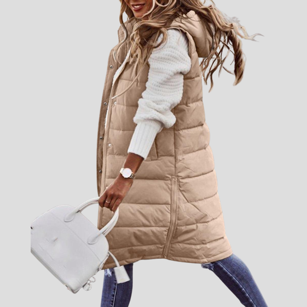 Women's long hooded bodywarmer vest with zip closure. Versatile sleeveless jacket for fall & winter fashion.