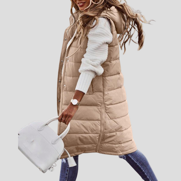 Women's long hooded bodywarmer vest with zip closure. Versatile sleeveless jacket for fall & winter fashion.