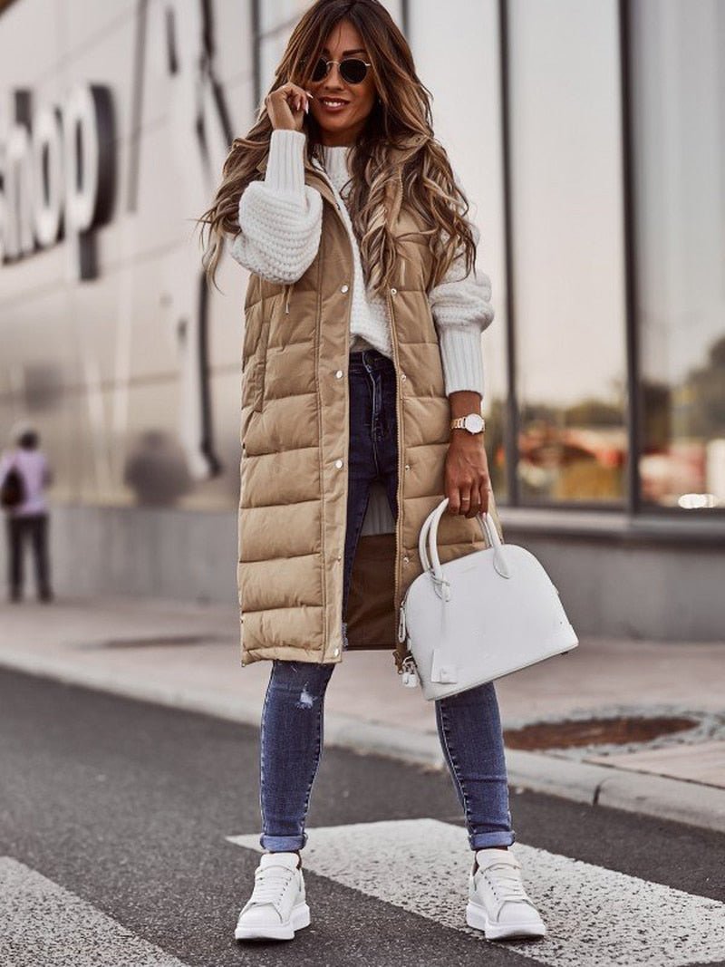 Stay cozy in this women's long hooded puffer vest. Stylish winter outerwear, a comfortable sleeveless layering piece.