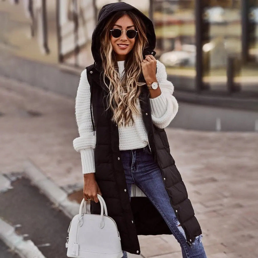 Women's long hooded puffer vest, quilted design, sleeveless, perfect for winter layering & warmth.