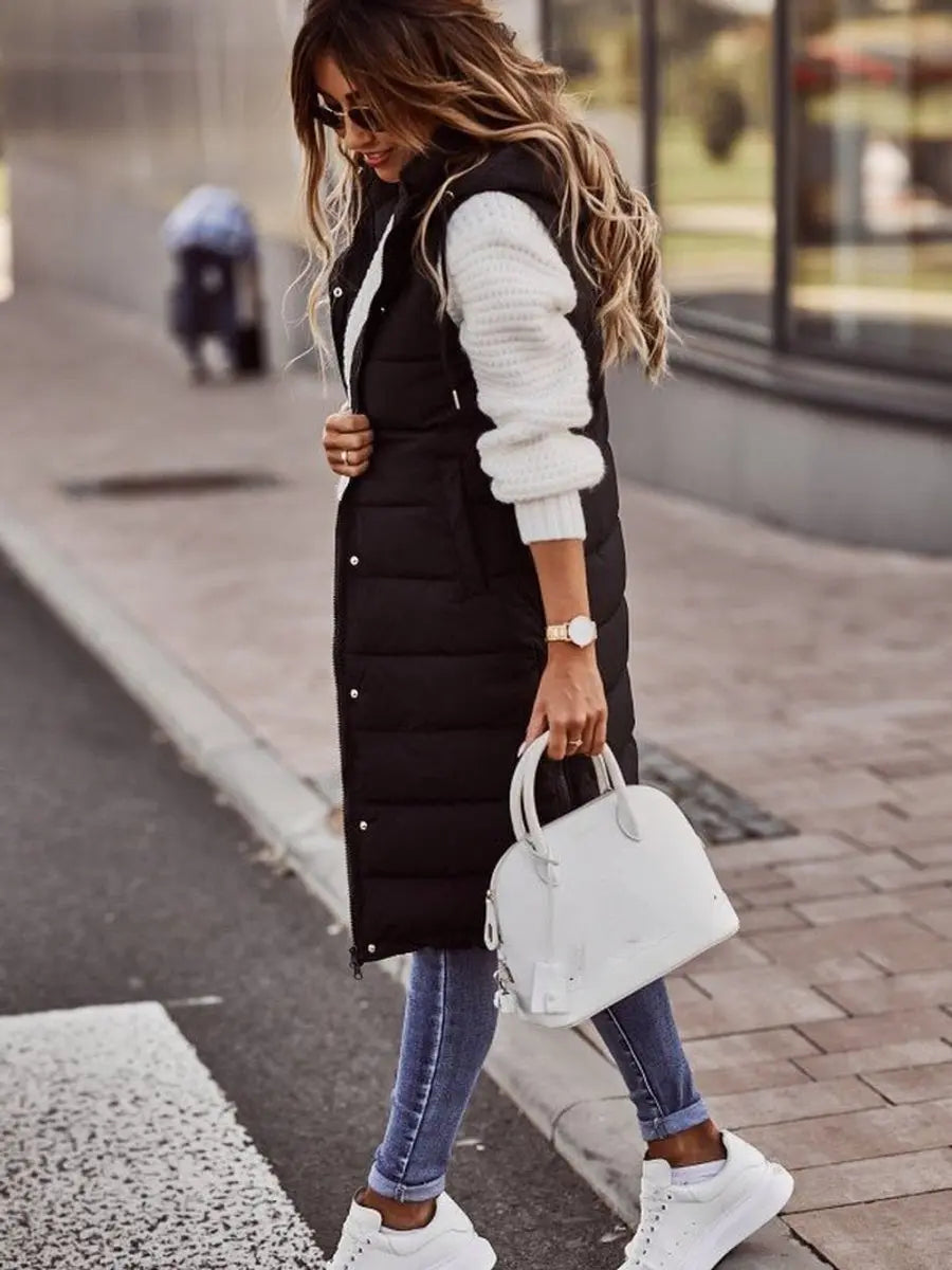 Stylish women's long quilted puffer gilet with hood, sleeveless, ideal for autumn & winter fashion outerwear.