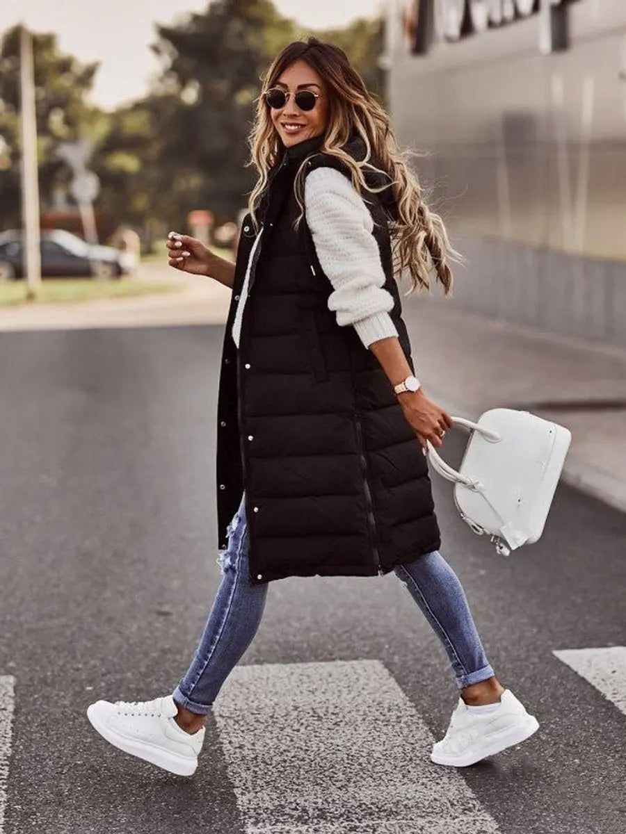 Warm women's long hooded puffer vest, quilted sleeveless design, ultimate comfort for chilly autumn & winter days.