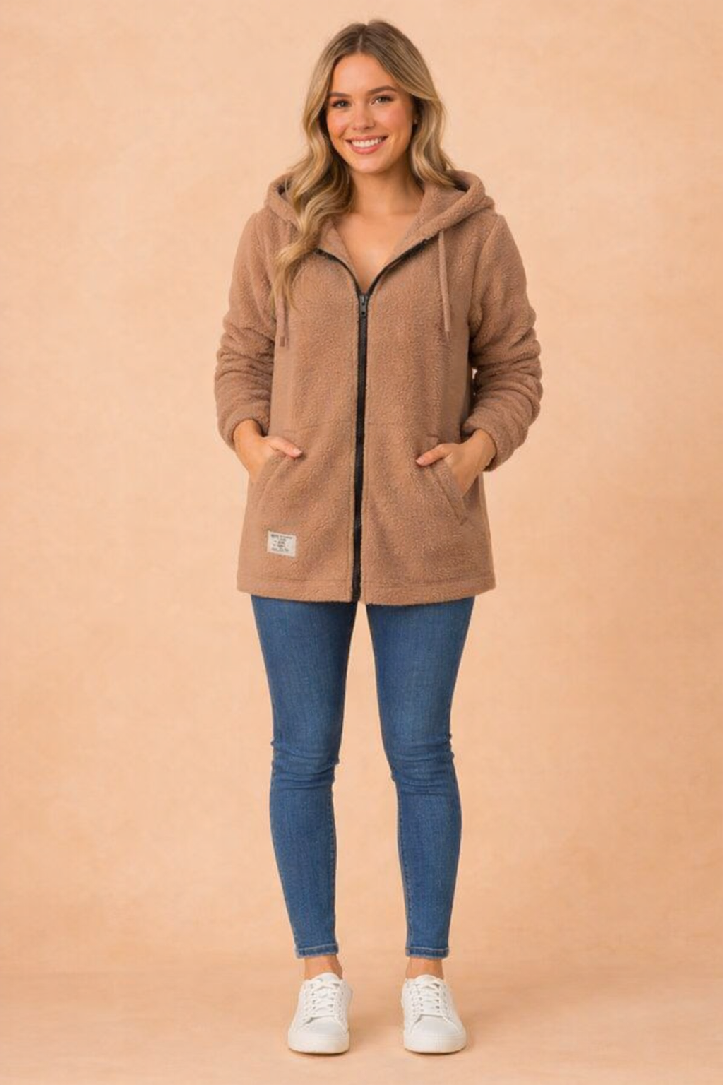 Model wearing a warm, long hooded winter jacket for women, showcasing its stylish design.