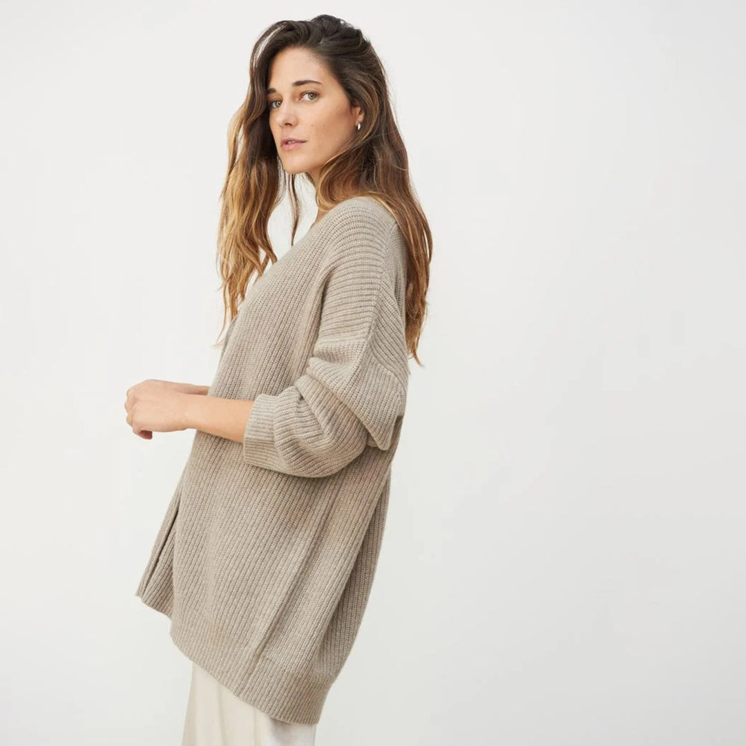 Modern women's long oversized cardigan, offering a comfortable relaxed fit and elegant open-front layering.