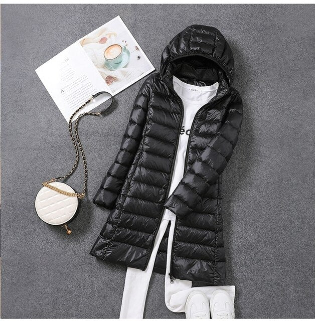 Stay cozy in this windproof & water-resistant long down jacket for women, with hood.