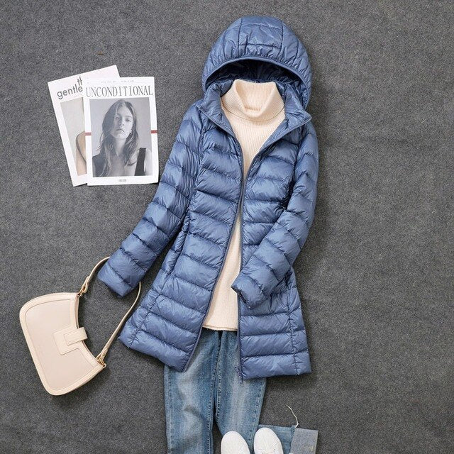 Versatile women's winter jacket: packable, long, down-filled, and includes a detachable hood.