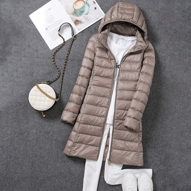 Essential women's packable down jacket with a detachable hood for ultimate winter comfort.
