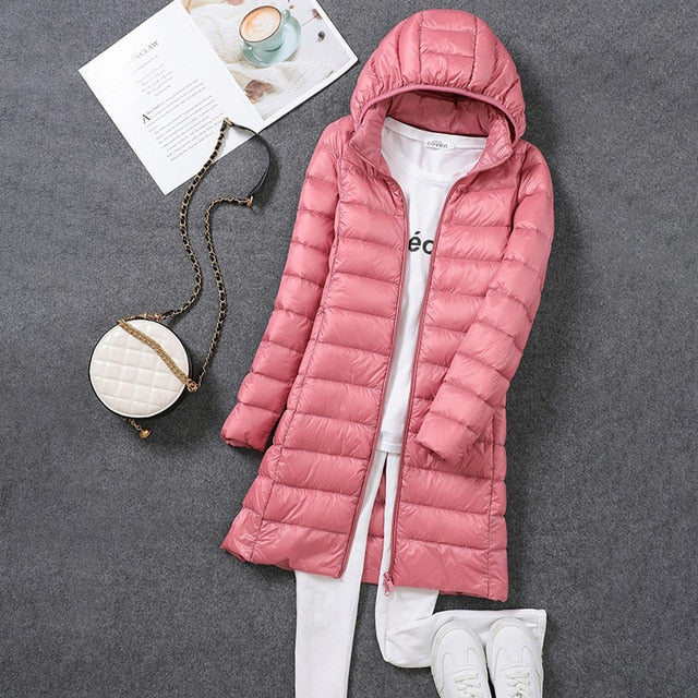 Fashionable and functional long down jacket for women, easily packable with a hood.