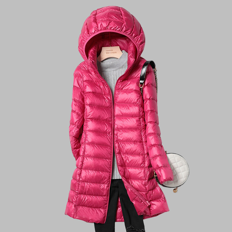 Durable, warm, and lightweight women's long down jacket with a convenient detachable hood.