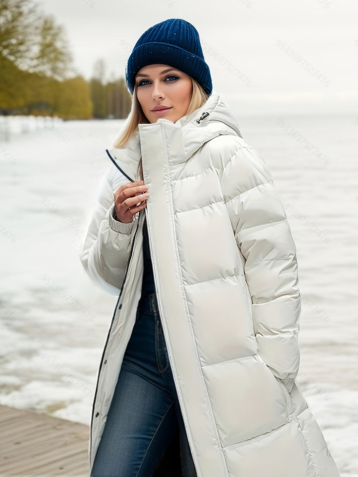 Functional women's long padded winter jacket with a hood, providing warmth & comfort outdoors.