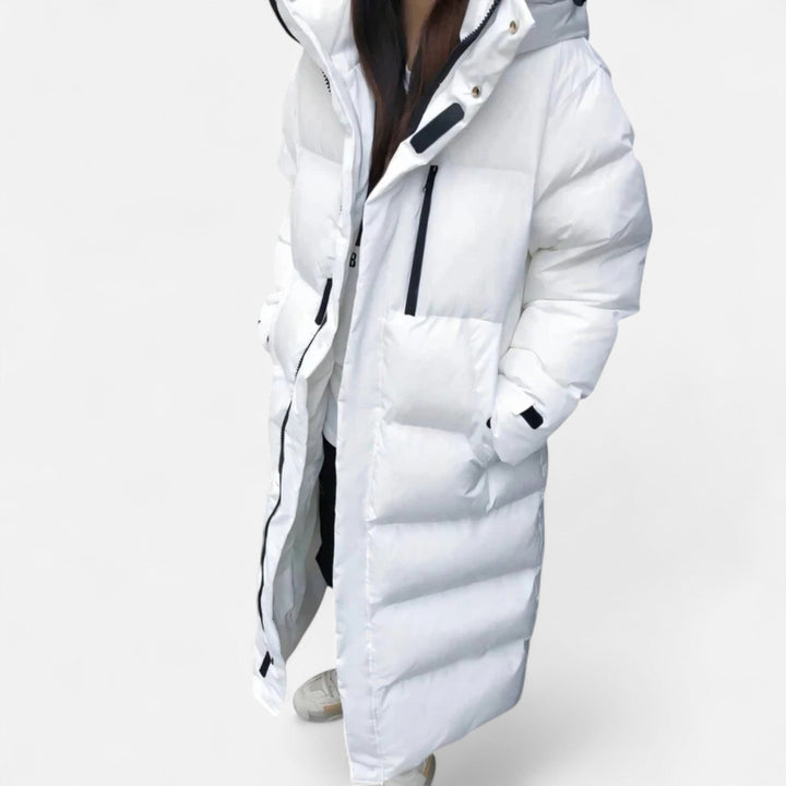 Cozy women's long puffer jacket, a stylish and modern winter coat. Ideal warm outerwear for ladies in cold weather.