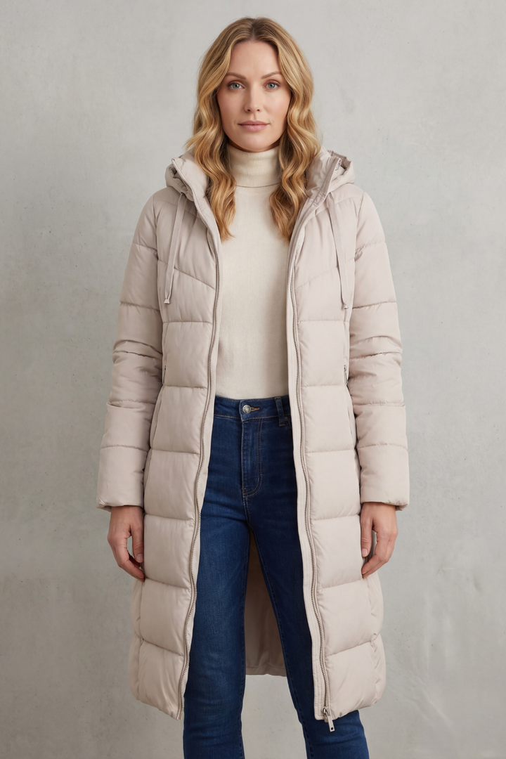 Ivory women's long quilted puffer coat. Warm, fashionable outerwear with a flattering fit for winter.