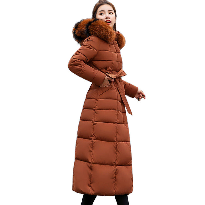 Model wearing the women's long quilted winter parka with hood up.
