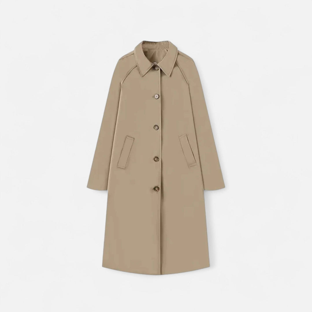 Elegant women's long black trench coat, retro heritage style, single-breasted outerwear.