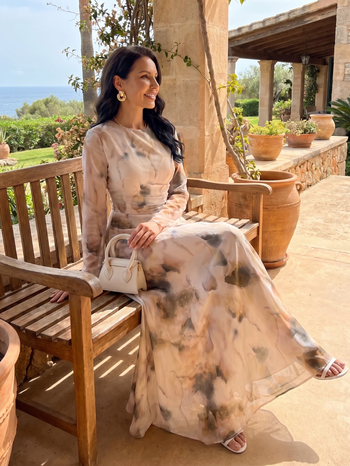 Elegant women's long sleeve maxi dress with an abstract print, round neck, and waist-defined silhouette. Stylish fashion.