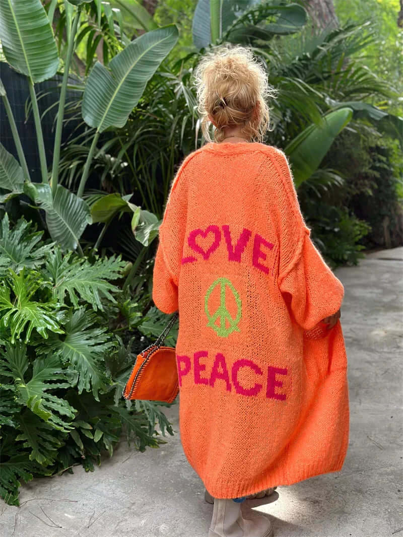 Women's long-sleeve cardigan with "Peace & Love" graphic. Cozy, stylish outerwear for spring/fall.
