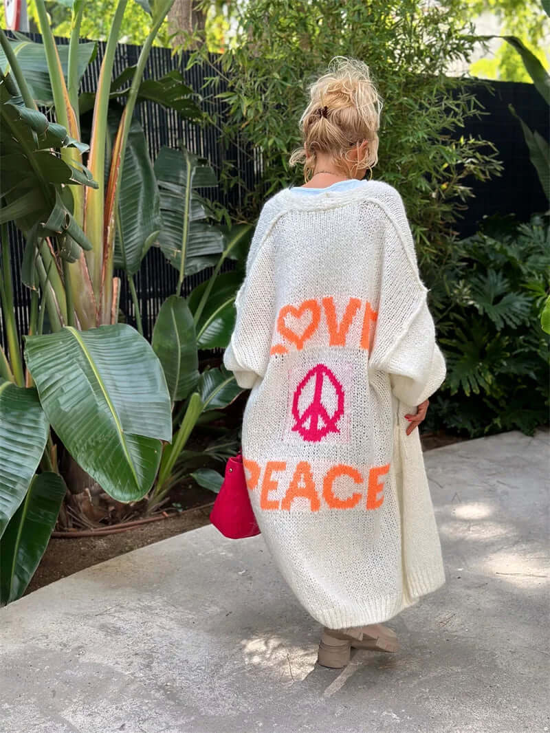 Comfortable women's cardigan featuring a unique "Peace & Love" graphic. Perfect casual layering piece.