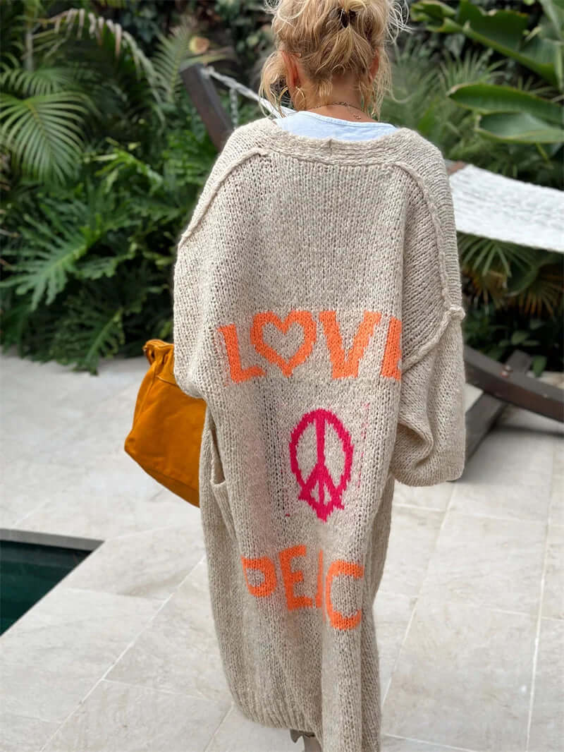 Stylish women's graphic sweater with vibrant "Peace & Love" design. Cozy long-sleeve cardigan for layering.