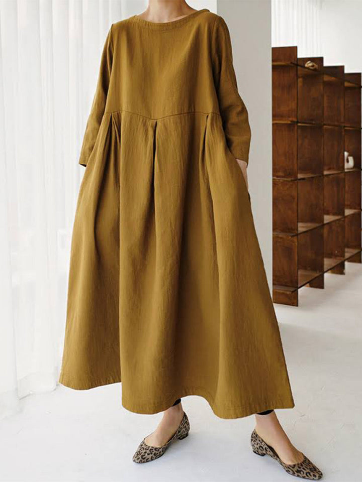 Relaxed fit women's long sleeve tiered maxi dress featuring a round neck & practical pockets, ensuring comfort & style.