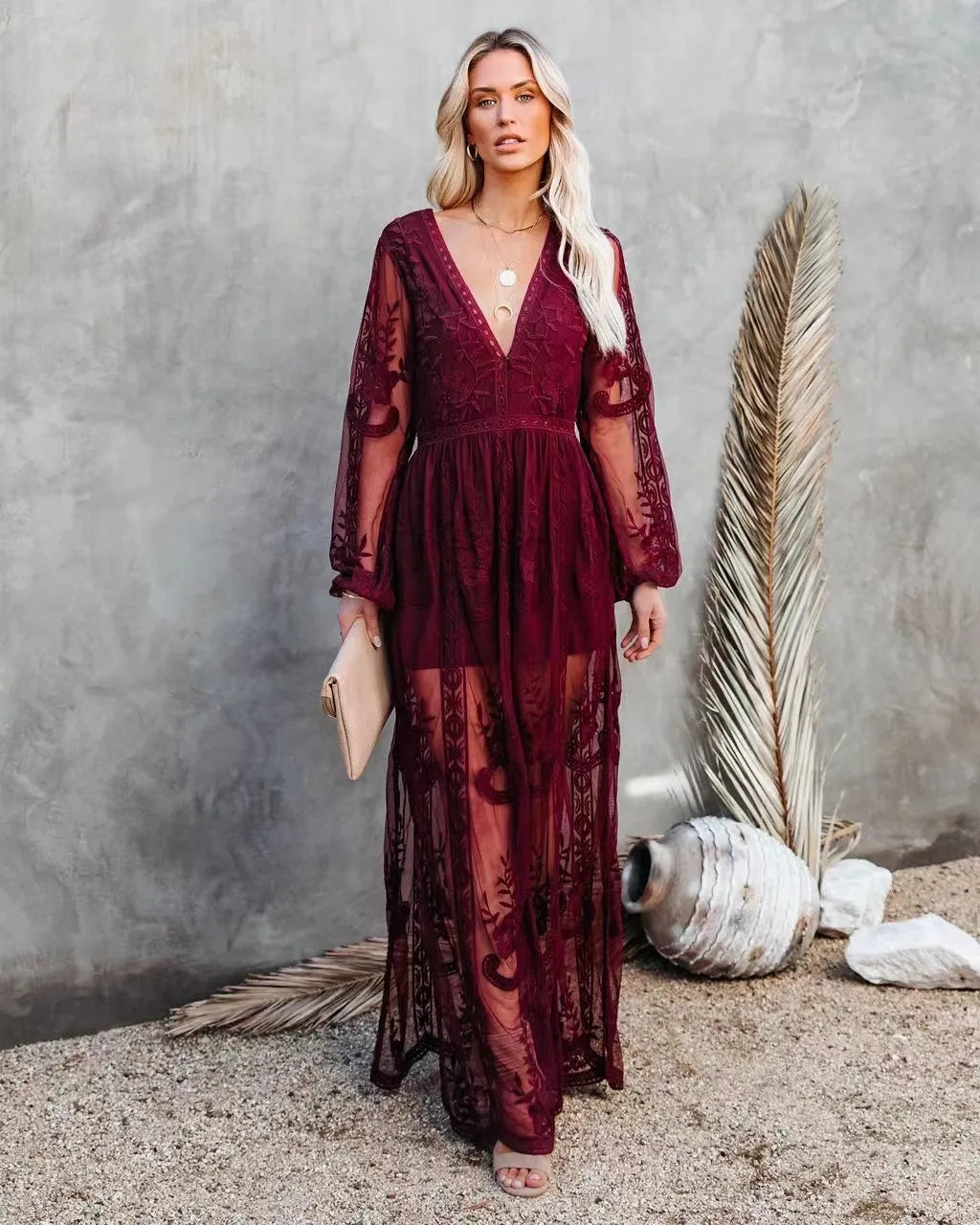 Luxurious women's sheer lace long sleeve maxi dress with V-neck & high slit, a sophisticated evening gown.