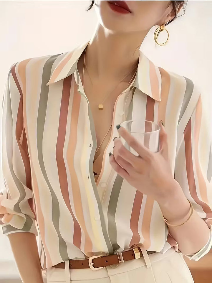 Comfortable women's striped button-up shirt, a versatile long-sleeve top for casual or professional looks.
