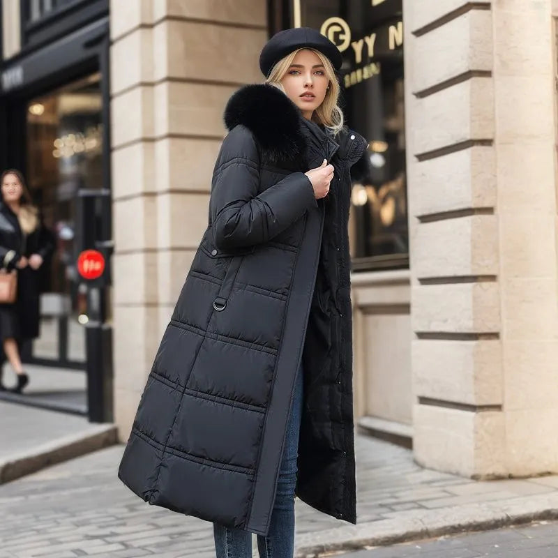 Women's elegant winter fashion: long coat with adjustable belt and fur.
