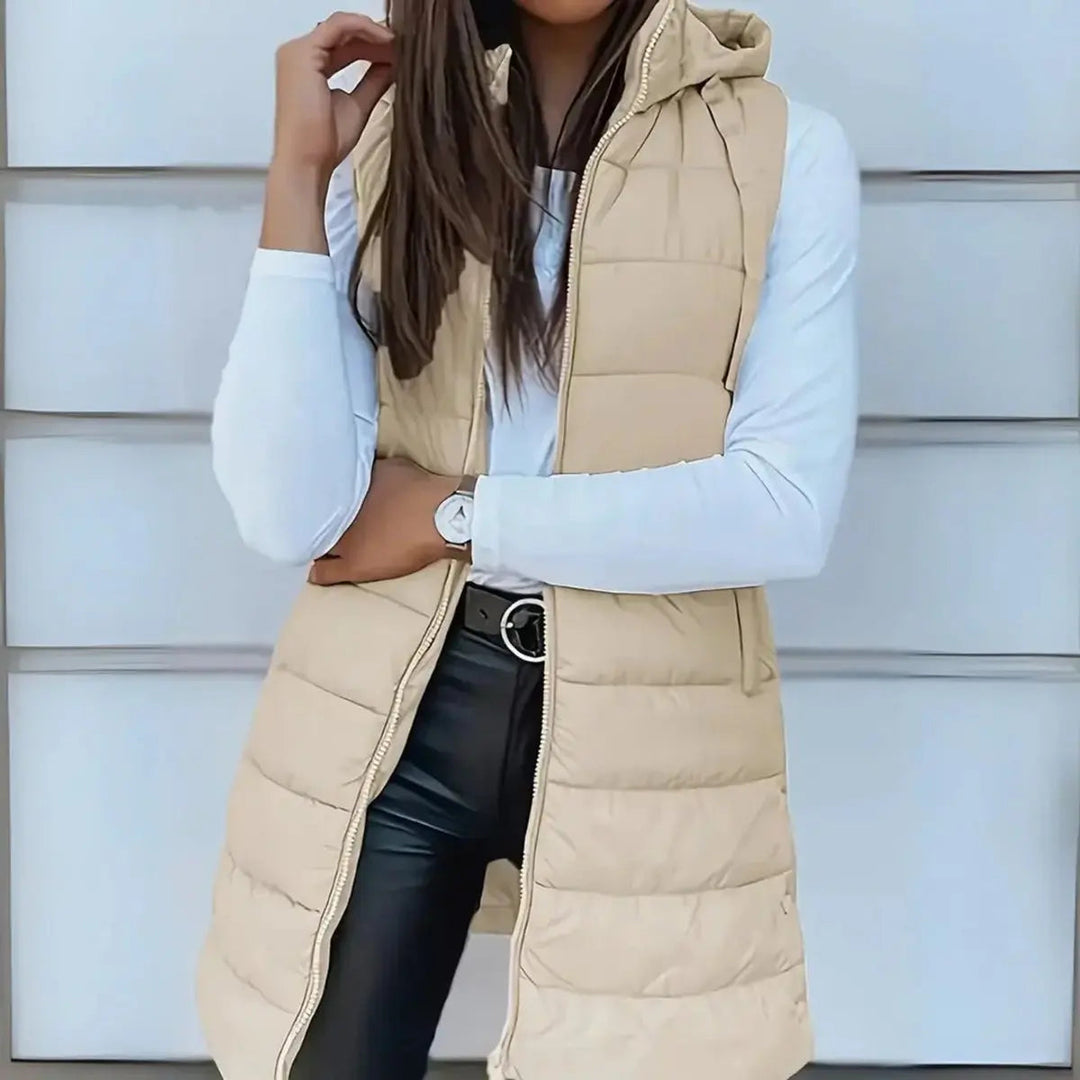 Versatile women's hooded puffer vest, ideal lightweight outerwear for transitional weather & layering.