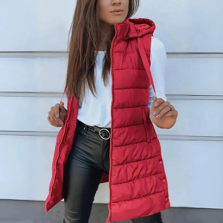 Fall essential: women's longline hooded puffer vest, providing lightweight warmth & stylish outerwear for cool days.