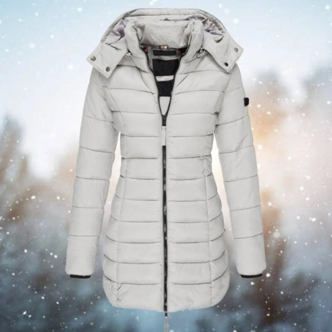 Fashionable women's longline hooded puffer jacket, quilted winter coat designed for warmth in cold weather.