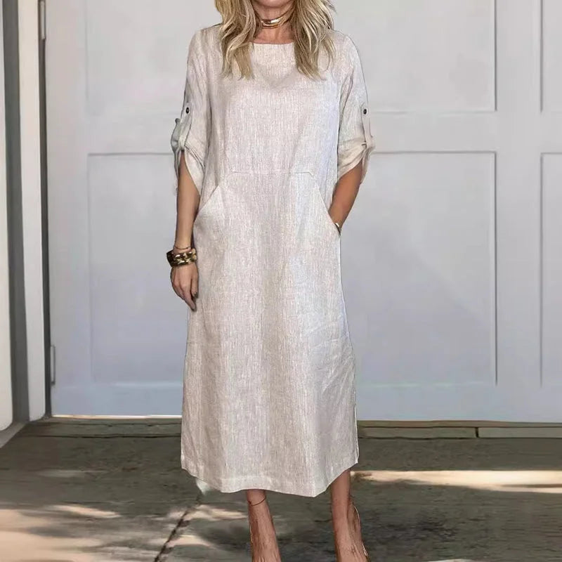 Women's loose A-line midi dress with roll-tab sleeves & pockets, perfect for casual summer fashion.