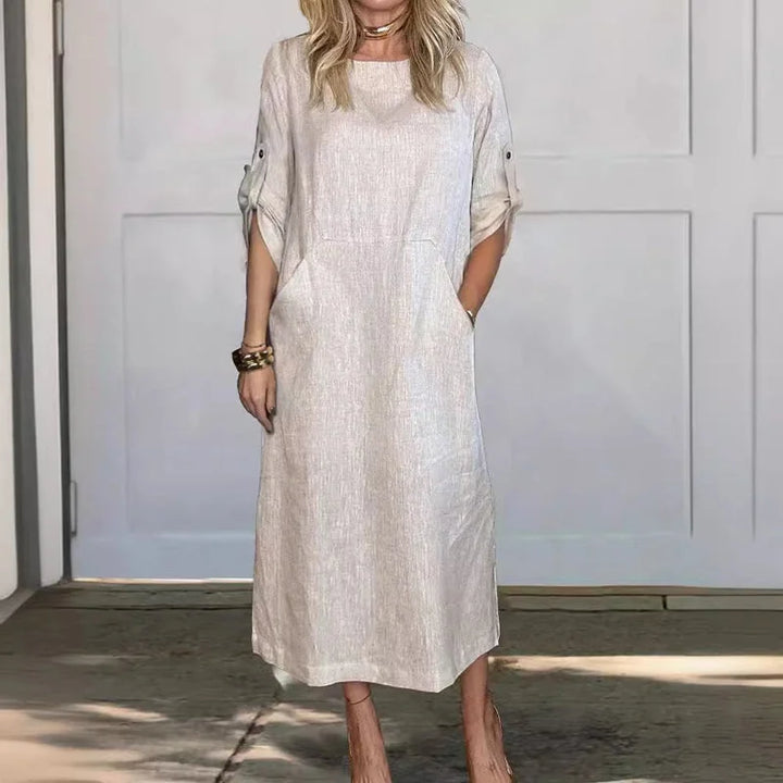 Women's loose A-line midi dress with roll-tab sleeves & pockets, perfect for casual summer fashion.