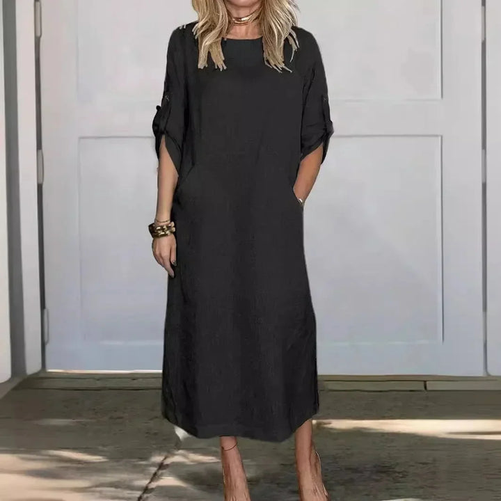Comfortable women's A-line midi dress with roll-tab sleeves and convenient pockets for everyday wear.