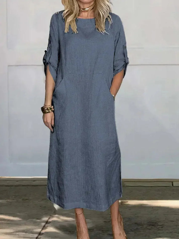 Stylish women's round neck midi dress featuring an A-line silhouette, roll-tab sleeves, and pockets.