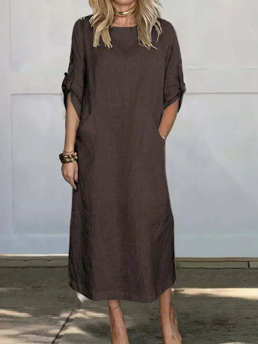 Elegant women's day dress: a comfortable A-line midi with handy pockets and fashionable roll-tab sleeves.