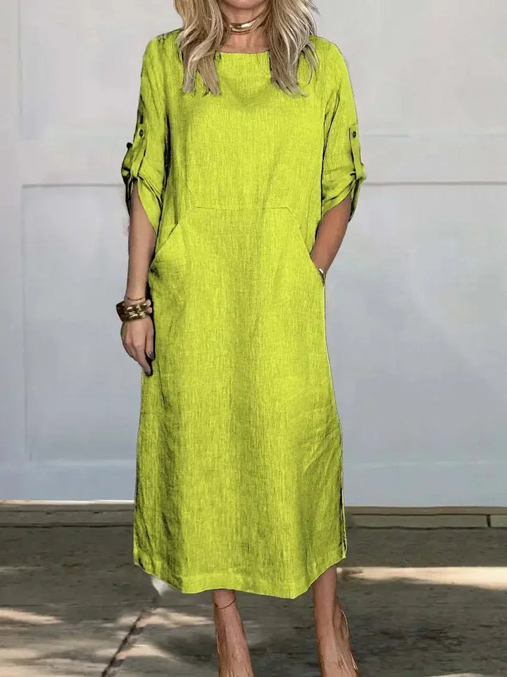 Women's summer A-line midi dress with a flattering loose fit, roll-tab sleeves, and functional side pockets.