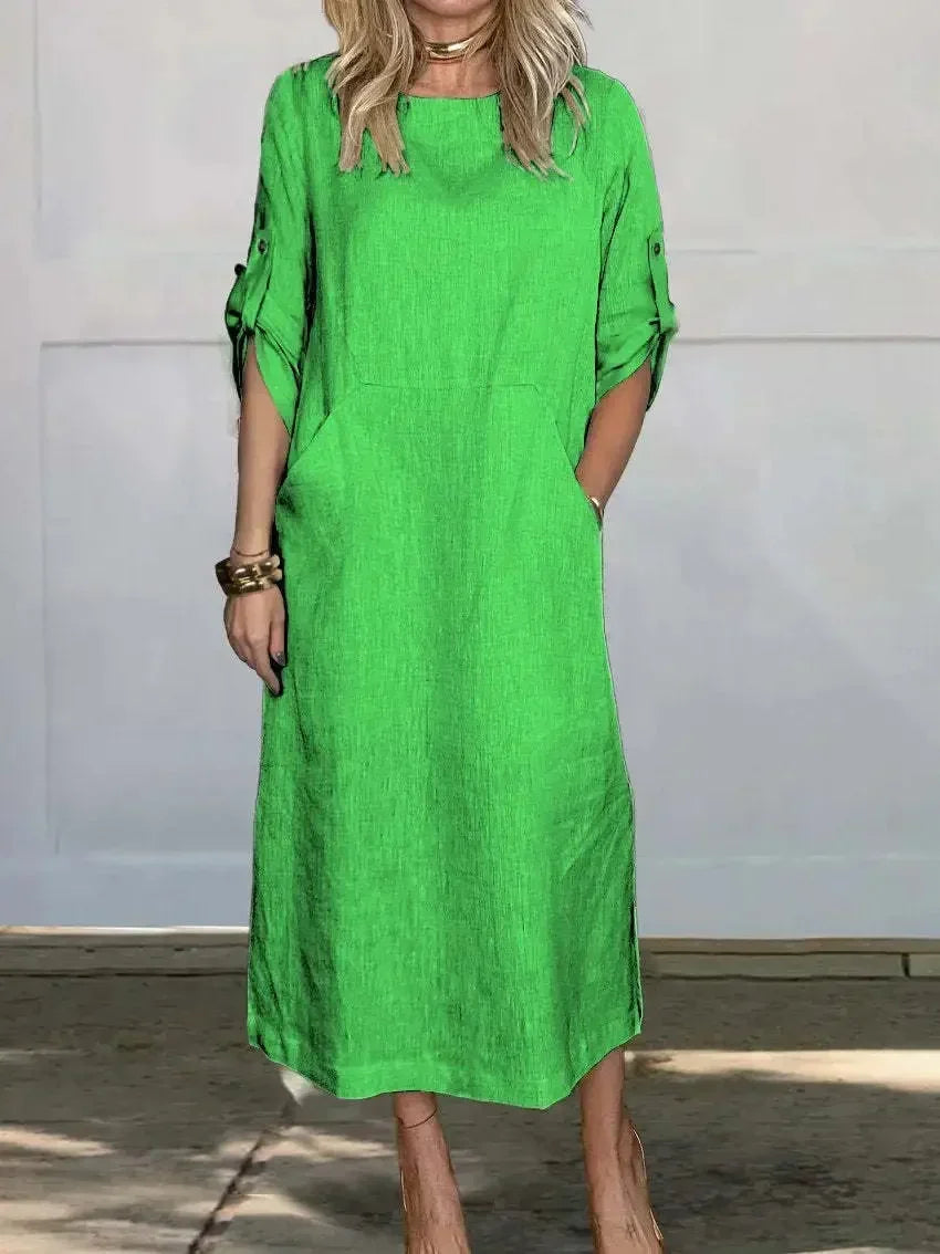 Casual women's A-line midi dress, featuring a comfortable design, roll-tab sleeves, and practical pockets.