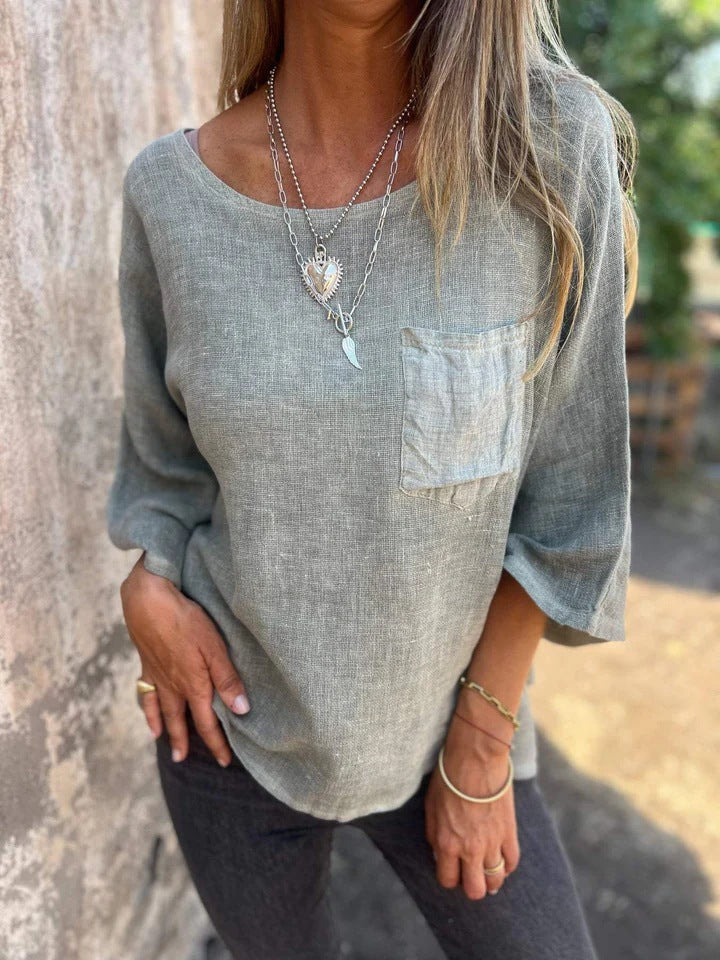Chic women's loose fit casual top with short sleeves, round neck, & chest pocket. Perfect for comfortable everyday style.