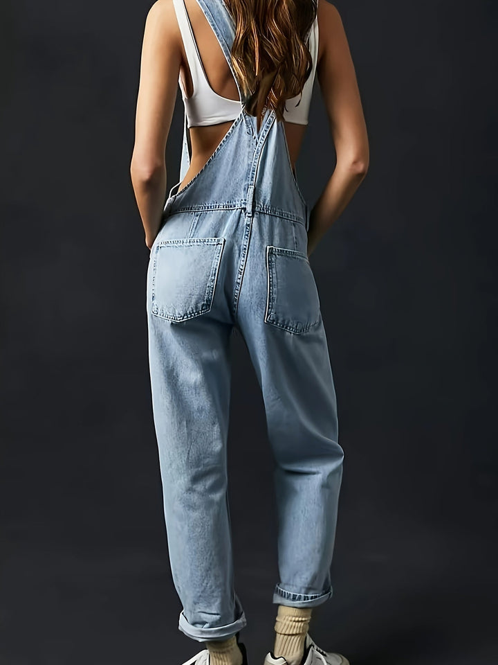 Women's casual denim overall with loose fit. Ladies dungarees featuring adjustable straps for comfort wear.