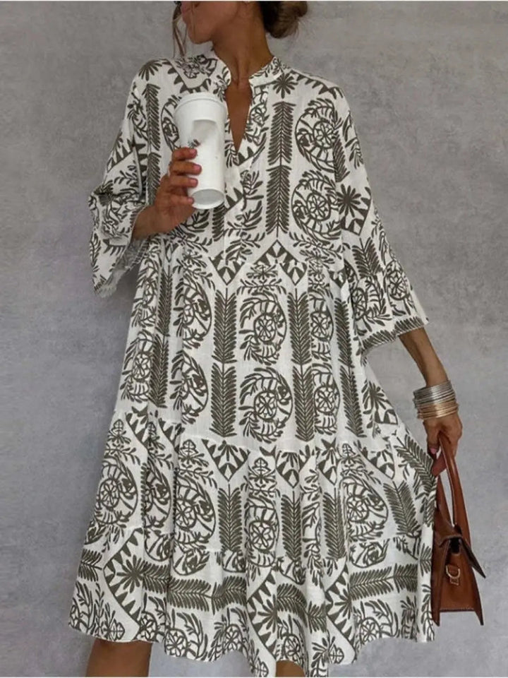 Model wearing a flowy floral print loose fit women's tunic dress for a relaxed summer look.