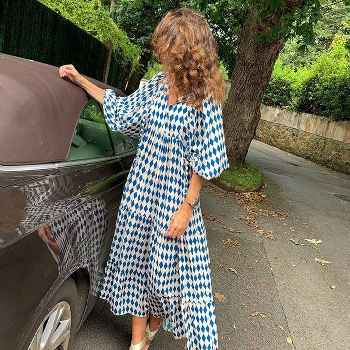Versatile knee-length women's dress, loose fit, printed, ruffled, ideal for casual daytime elegance.