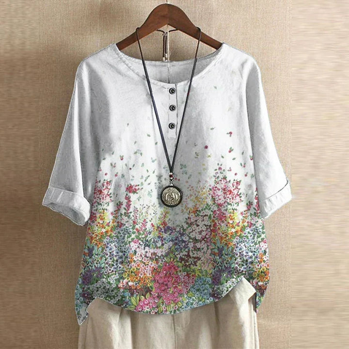 Back view of a loose fit women's tunic blouse, emphasizing comfortable oversized summer fashion.
