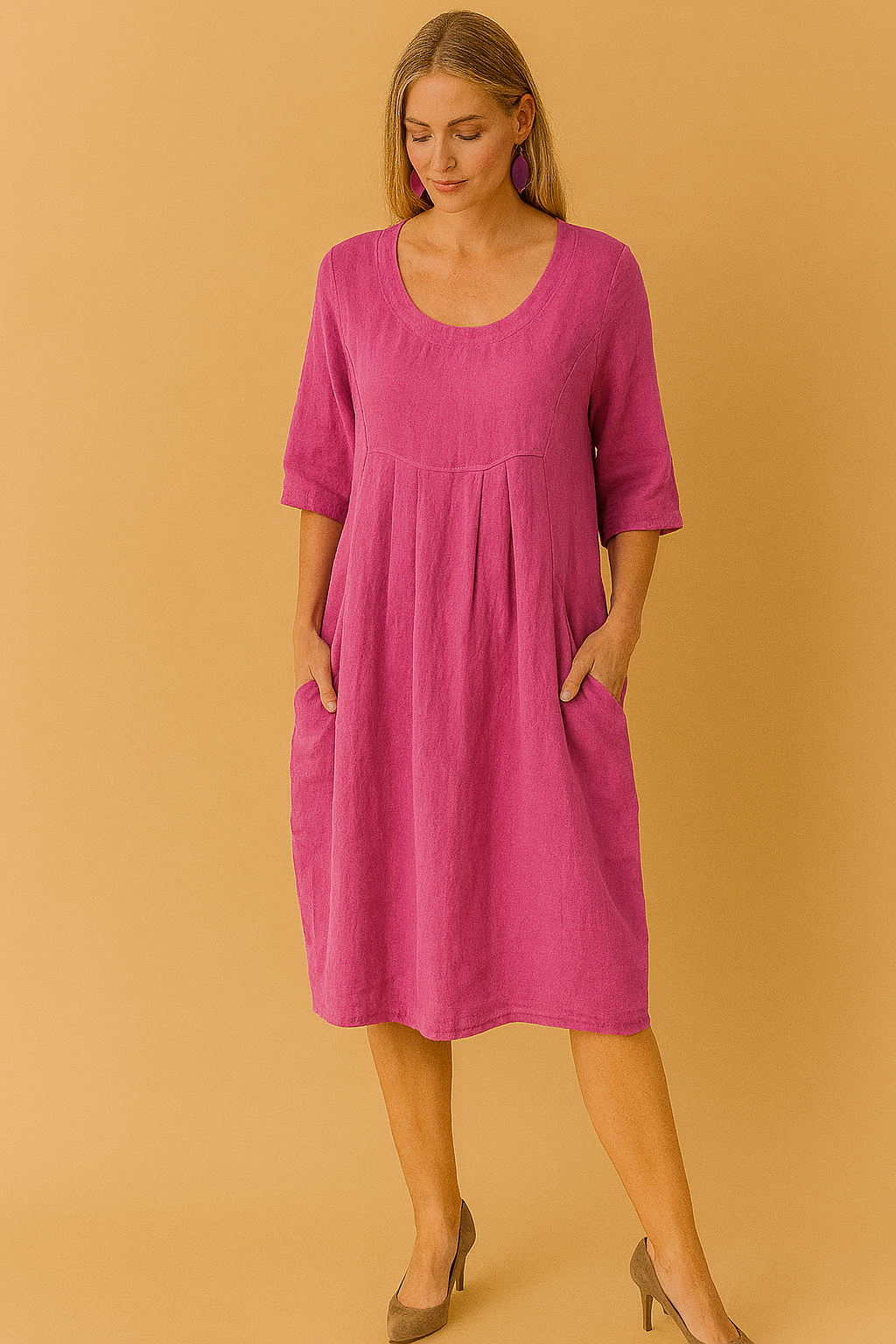 Woman wearing a stylish knee-length loose fit t-shirt dress. Features a round neck, short sleeves, and practical pockets.
