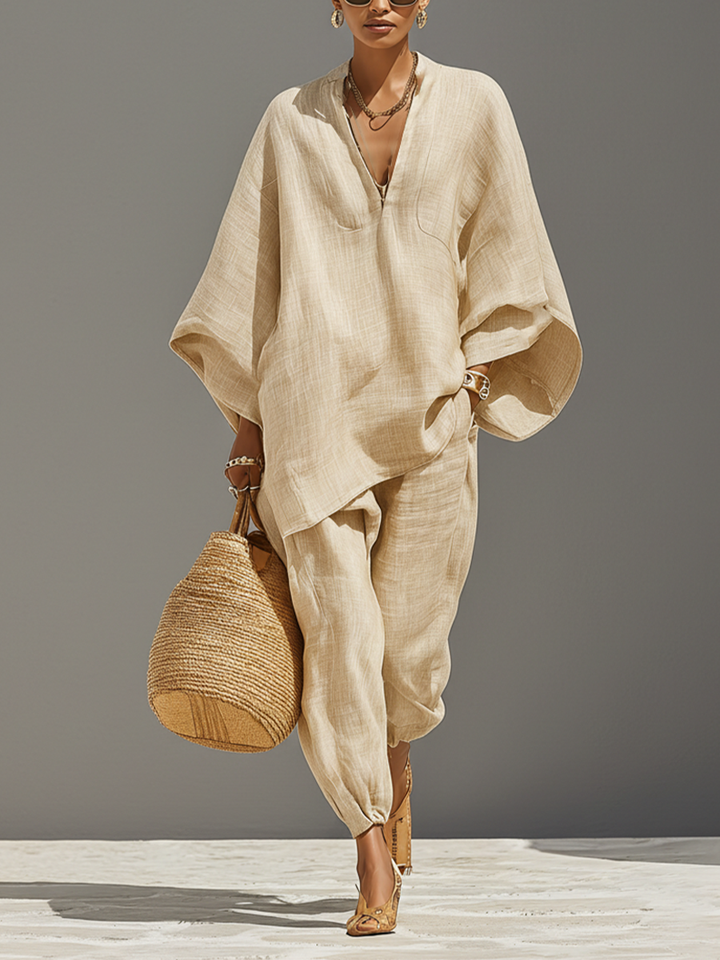 Women's loose oversized two-piece loungewear set with notched top & tapered pants, comfy chic.