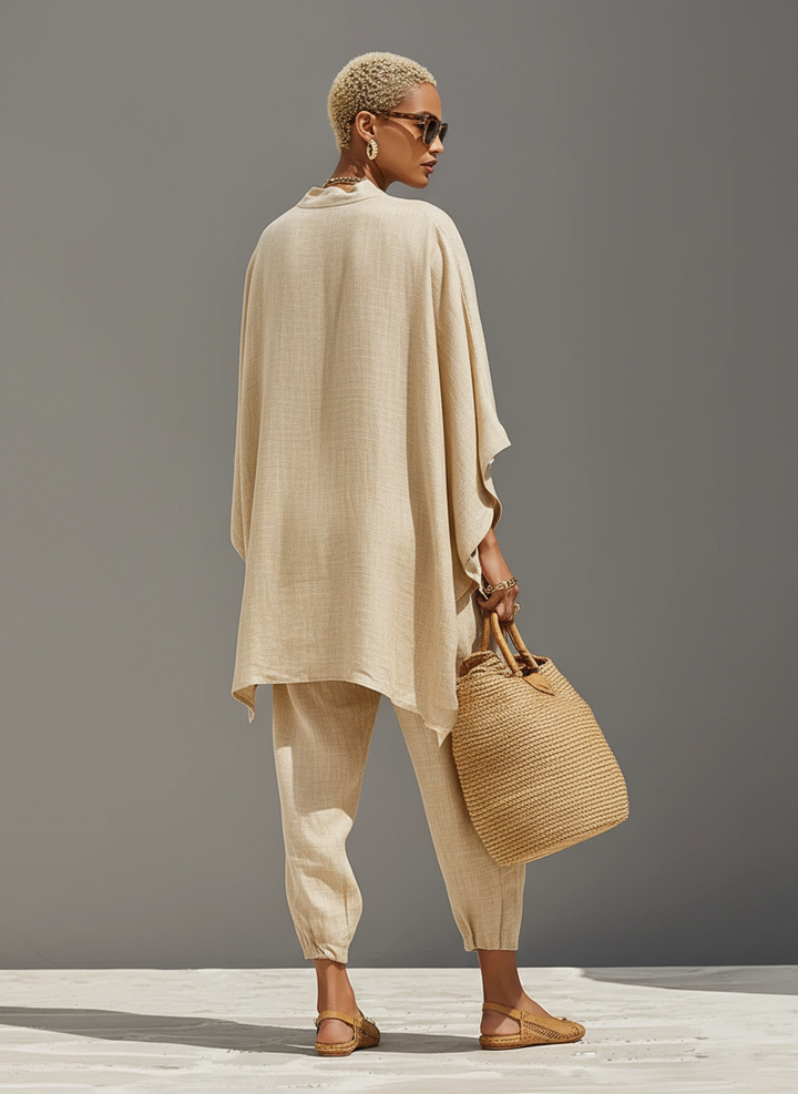 Relaxed women's two-piece outfit: comfy notched top & tapered pants, ideal for home or casual wear.